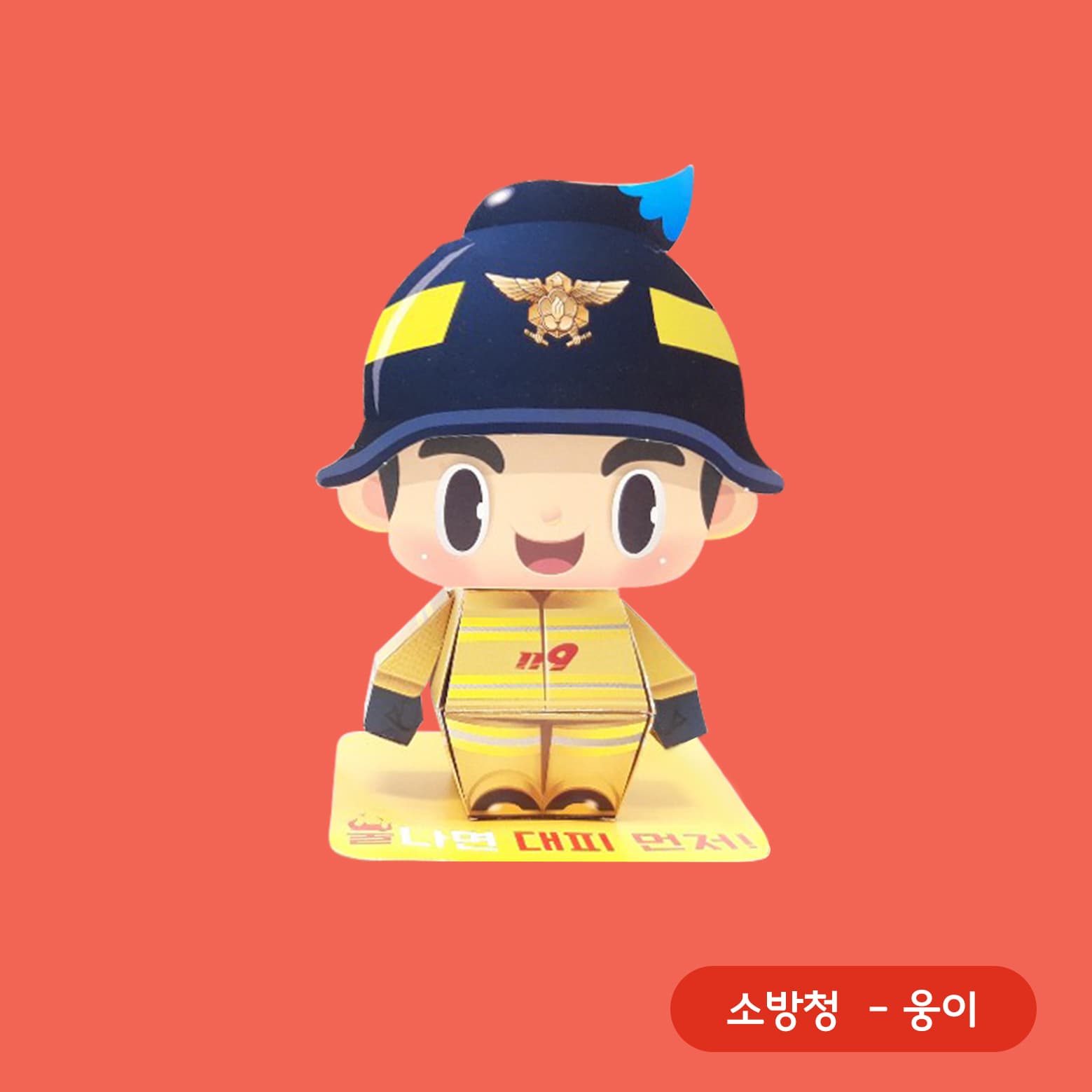 파란 물방울 장식을 헬멧에 단 웅이가 노란 119 방화복 차림으로 붉은 배경 앞 노란 받침대에 선 액션 페이퍼